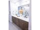 Modern bathroom features a double vanity, sleek fixtures, and a large mirror reflecting a glass-enclosed shower at 451 Old Town Village Rd, Waxhaw, NC 28173