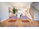 Hallway with a view into the eat-in kitchen and formal dining room with access to the staircase at 451 Old Town Village Rd, Waxhaw, NC 28173
