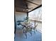 Covered patio with fan, a table with four chairs, and black metal railings with a view of the trees at 451 Old Town Village Rd, Waxhaw, NC 28173