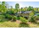 Beautifully landscaped backyard surrounded by mature trees, with nice lawn at 556 Westwood Dr, Kannapolis, NC 28081