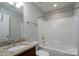 Bathroom with a granite countertop vanity, shower, and bathtub combo at 556 Westwood Dr, Kannapolis, NC 28081