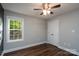 A bedroom featuring hardwood floors and a window with green tree views at 556 Westwood Dr, Kannapolis, NC 28081