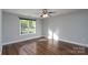 Bright bedroom featuring hardwood floors, neutral paint, and a large window at 556 Westwood Dr, Kannapolis, NC 28081