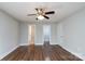 Spacious bedroom with neutral walls, ceiling fan, hardwood floors, and closet access at 556 Westwood Dr, Kannapolis, NC 28081