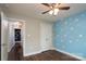 Bright bedroom featuring wood floors, a ceiling fan, and access to a closet at 556 Westwood Dr, Kannapolis, NC 28081