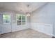 Dining room with wainscoting, tile floor and lots of natural light at 556 Westwood Dr, Kannapolis, NC 28081