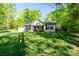 Attractive home boasting great curb appeal with its well-manicured lawn, fresh landscaping, and covered front entrance at 556 Westwood Dr, Kannapolis, NC 28081