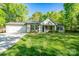 Charming single-Gathering home featuring a lush green lawn, a two-car garage, and a cozy front porch at 556 Westwood Dr, Kannapolis, NC 28081
