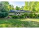 Charming home nestled among mature trees with manicured landscaping at 556 Westwood Dr, Kannapolis, NC 28081