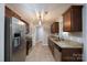 A well-lit kitchen with stainless steel appliances, granite countertops, and a seamless flow to the dining area at 556 Westwood Dr, Kannapolis, NC 28081