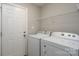 Laundry room equipped with a washer, dryer, and utility shelving at 556 Westwood Dr, Kannapolis, NC 28081