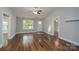 Bright living room with beautiful wood floors, fresh paint, a ceiling fan, and ample natural light at 556 Westwood Dr, Kannapolis, NC 28081