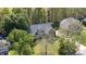 Aerial view of a charming home surrounded by mature trees and a well-maintained lawn at 585 Highland Ridge Rd, Mooresville, NC 28115
