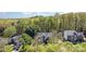 Aerial view of a beautiful home with mature trees, lush landscaping, and ample parking at 585 Highland Ridge Rd, Mooresville, NC 28115