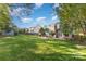 Spacious backyard featuring a patio with outdoor seating, a lush lawn, and mature trees at 585 Highland Ridge Rd, Mooresville, NC 28115