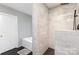 Beautiful bathroom featuring a tiled shower and separate bathtub with a grey accent wall at 585 Highland Ridge Rd, Mooresville, NC 28115