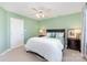 Green bedroom features a ceiling fan, a bed with side tables, and a white closet door at 585 Highland Ridge Rd, Mooresville, NC 28115