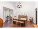 Dining room featuring wood floors, large windows, chandelier, and rustic furnishings at 585 Highland Ridge Rd, Mooresville, NC 28115