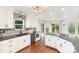 Bright kitchen features white cabinetry, island with seating, and stainless steel appliances at 585 Highland Ridge Rd, Mooresville, NC 28115