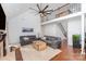 Spacious living room featuring vaulted ceilings, fireplace, a fan, and hardwood floors at 585 Highland Ridge Rd, Mooresville, NC 28115