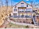 Back exterior view featuring a multi-tiered deck, stairs, balcony and a long winding walkway at 5888 Wood Duck Way, Catawba, NC 28609