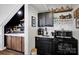 Stylish bar area with black cabinets, marble countertops, and a well-stocked beverage display at 5888 Wood Duck Way, Catawba, NC 28609