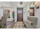 Foyer featuring a wooden door, bench, mirror and a view into the living and dining rooms at 5888 Wood Duck Way, Catawba, NC 28609