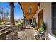 Front porch featuring stone columns, wood ceiling and floors, plants, and an inviting entrance at 5888 Wood Duck Way, Catawba, NC 28609