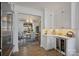 Bright kitchen showcasing white cabinetry, built-in wine cooler, marble counters, and adjacent dining area at 5888 Wood Duck Way, Catawba, NC 28609