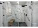 Modern bathroom showcasing a glass shower with marble-patterned tiles and matte black fixtures at 5888 Wood Duck Way, Catawba, NC 28609