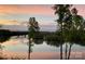 Scenic river view featuring a tranquil sunset, trees, and a bridge in the distance at 5888 Wood Duck Way, Catawba, NC 28609