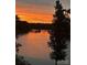 Sunset view of a river with a bridge in the distance, casting a warm glow over the water at 5888 Wood Duck Way, Catawba, NC 28609
