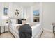 Comfortable bedroom featuring large windows, a soft rug, and a well-decorated bed with stylish pillows at 606 S 10Th St, Bessemer City, NC 28016