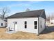 Exterior view of a house showcasing its gray siding, dark roof, and compact structure from an angled perspective at 606 S 10Th St, Bessemer City, NC 28016
