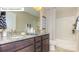 Bathroom features a double vanity with granite countertops and a tub at 7027 Butternut Oak Ter, Huntersville, NC 28078