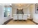 Elegant dining room featuring tray ceilings, decorative wallpaper, and sunlit windows at 7027 Butternut Oak Ter, Huntersville, NC 28078