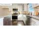 Modern kitchen featuring stainless steel appliances, white cabinets, and sleek granite countertops at 7027 Butternut Oak Ter, Huntersville, NC 28078