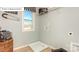 The laundry room includes a window, shelving, and space for washing at 7027 Butternut Oak Ter, Huntersville, NC 28078