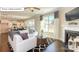 Spacious living area with a fireplace, large windows, and open to the kitchen at 7027 Butternut Oak Ter, Huntersville, NC 28078