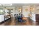 Open-concept living space with dark wood floors, a modern kitchen, and inviting dining area at 7027 Butternut Oak Ter, Huntersville, NC 28078