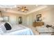 The main bedroom features a tray ceiling and a seating area with a comfy chair and ottoman at 7027 Butternut Oak Ter, Huntersville, NC 28078