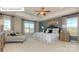 This main bedroom has a tray ceiling, ceiling fan, and 2 large windows for lots of natural light at 7027 Butternut Oak Ter, Huntersville, NC 28078