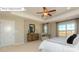 Main bedroom boasts neutral walls, tray ceiling, ceiling fan, and 2 windows with neighborhood views at 7027 Butternut Oak Ter, Huntersville, NC 28078
