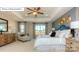 The main bedroom features an upholstered headboard and an upholstered chair in the seating area at 7027 Butternut Oak Ter, Huntersville, NC 28078