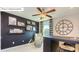 The office offers shelves, ceiling fan, and a comfortable seating area by the window at 7027 Butternut Oak Ter, Huntersville, NC 28078
