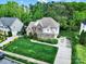 Aerial view of a beautiful two-story home with well-maintained landscaping and a lush green lawn at 7935 Harrington Woods Rd, Charlotte, NC 28269