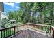 Wooden back deck overlooking the lush, green wooded backyard at 7935 Harrington Woods Rd, Charlotte, NC 28269