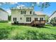 Back exterior view of the home featuring a wooden deck and large backyard at 7935 Harrington Woods Rd, Charlotte, NC 28269