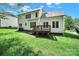 Back exterior view of the home featuring a wooden deck and large backyard at 7935 Harrington Woods Rd, Charlotte, NC 28269