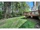 Spacious backyard featuring a wooden deck and mature trees at 7935 Harrington Woods Rd, Charlotte, NC 28269